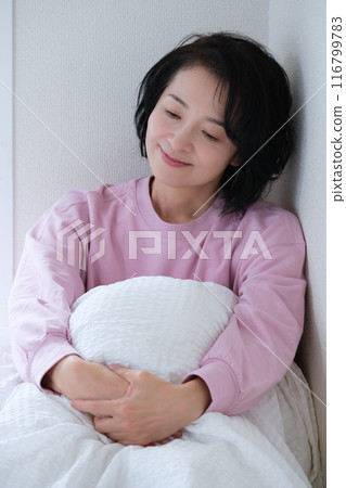 A middle-aged woman having a refreshing morning A middle-aged woman having a refreshing morning 116799783