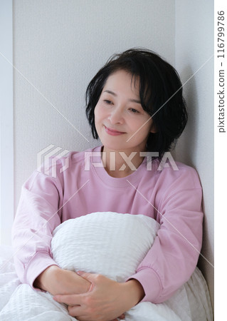 A middle-aged woman having a refreshing morning 116799786