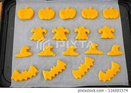 I made pumpkin, ghost, witch hat, and bat shaped cookies for Halloween. I lined them up on a hot plate. I made pumpkin, ghost, witch hat, and bat shaped cookies for Halloween. I lined them up on a hot plate. 116801574