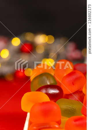 Christmas Gummy Colorful Candy on Garland Background. 116802173