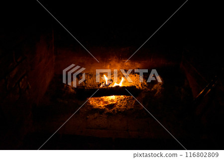 Warm fire in the fireplace Warm fire in the fireplace 116802809