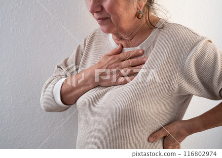 Woman having a pain in the heart area. Heart Attack.  116802974