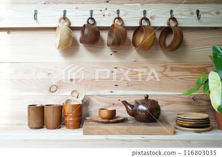 tea cup and wooden teapot on wooden counter tea cup and wooden teapot on wooden counter 116803035