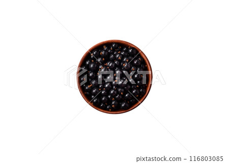 Ripe blackcurrant berries in droplets of water in a ceramic bowl Ripe blackcurrant berries in droplets of water in a ceramic bowl 116803085