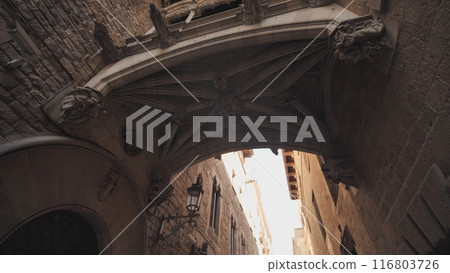 Bridge between buildings in Barri Gotic quarter of Barcelona, Spain. 116803726