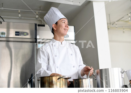 Young asian male chef preparing food in the kitchen 116803904