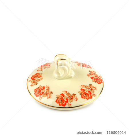 Porcelain lid from a sugar bowl with an elegant pattern isolated on a white. Porcelain lid from a sugar bowl with an elegant pattern isolated on a white. 116804014