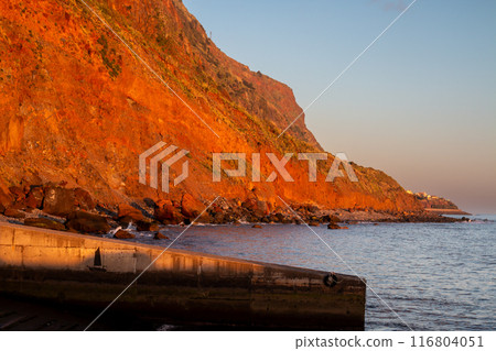 Bright orange cliff during golden hour, Madeira Bright orange cliff during golden hour, Madeira 116804051