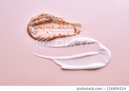 Cream and cream scrub on a pink background. Texture. Cream and cream scrub on a pink background. Texture. 116804324
