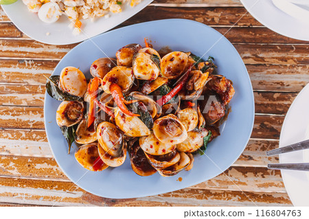 Thai seafood dish, Stir Fried Squids with Red Curry Paste on table. Thai seafood dish, Stir Fried Squids with Red Curry Paste on table. 116804763