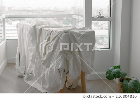 White bed sheets hanging after wash at the balcony in the apartment. White bed sheets hanging after wash at the balcony in the apartment. 116804810