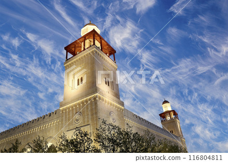King Hussein Bin Talal mosque in Amman (at night), Jordan. Against the background of a beautiful sky with clouds King Hussein Bin Talal mosque in Amman (at night), Jordan. Against the background of a beautiful sky with clouds 116804811