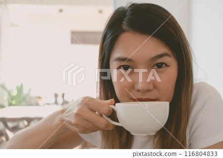 Woman is receiving a coffee cup and drink. Woman is receiving a coffee cup and drink. 116804833