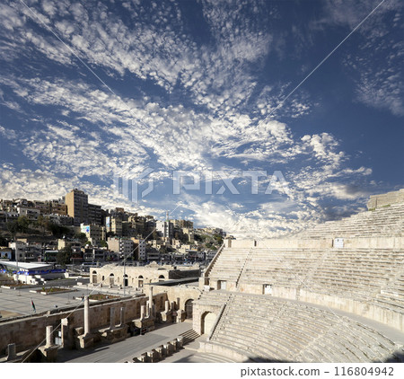 Roman Theatre in Amman, Jordan -- theatre was built the reign of Antonius Pius (138-161 CE), the large and steeply raked structure could seat about 6000 people. Against the sky with clouds 116804942