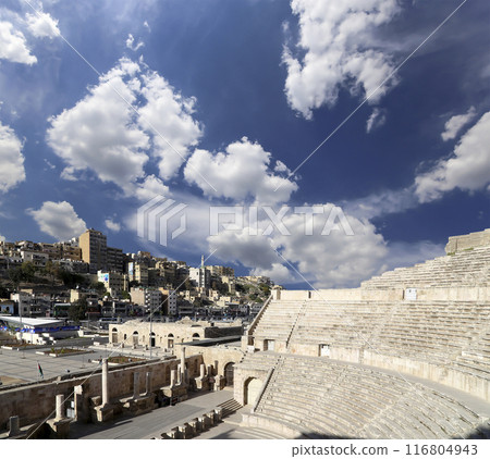 Roman Theatre in Amman, Jordan -- theatre was built the reign of Antonius Pius (138-161 CE), the large and steeply raked structure could seat about 6000 people. Against the sky with clouds 116804943