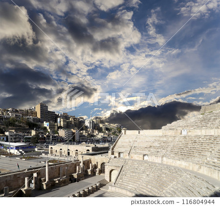 Roman Theatre in Amman, Jordan -- theatre was built the reign of Antonius Pius (138-161 CE), the large and steeply raked structure could seat about 6000 people. Against the sky with clouds 116804944