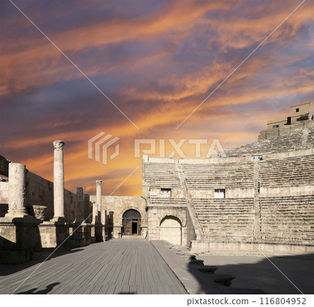 Roman Theatre in Amman, Jordan -- theatre was built the reign of Antonius Pius (138-161 CE), the large and steeply raked structure could seat about 6000 people. Against the sky with clouds 116804952