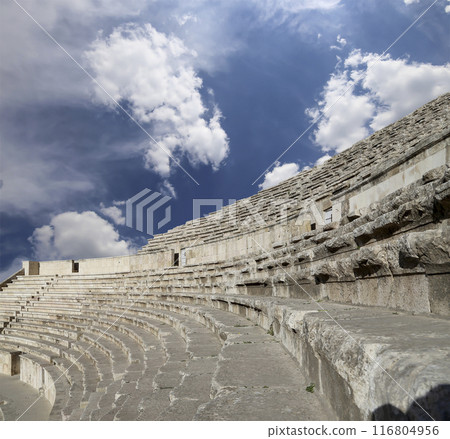 Roman Theatre in Amman, Jordan -- theatre was built the reign of Antonius Pius (138-161 CE), the large and steeply raked structure could seat about 6000 people. Against the sky with clouds Roman Theatre in Amman, Jordan -- theatre was built the reign of Antonius Pius (138-161 CE), the large and steeply raked structure could seat about 6000 people. Against the sky with clouds 116804956