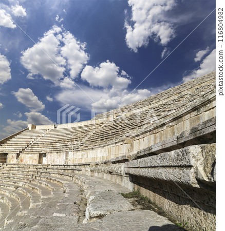 Roman Theatre in Amman, Jordan -- theatre was built the reign of Antonius Pius (138-161 CE), the large and steeply raked structure could seat about 6000 people. Against the sky with clouds Roman Theatre in Amman, Jordan -- theatre was built the reign of Antonius Pius (138-161 CE), the large and steeply raked structure could seat about 6000 people. Against the sky with clouds 116804982