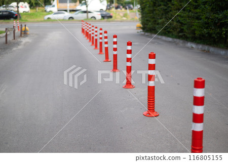 Road sign flexible plastic bollards with pedestrian white marking line and arrow sign on cement floor in parking car park area Road sign flexible plastic bollards with pedestrian white marking line and arrow sign on cement floor in parking car park area 116805155