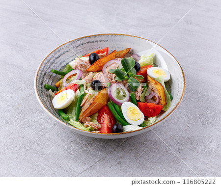 Salad with canned tuna, salad nicoise, on a gray background for a food delivery site menu Salad with canned tuna, salad nicoise, on a gray background for a food delivery site menu 116805222