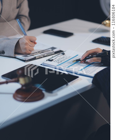 Judge gavel with Justice lawyers having team meeting at law firm background. Concepts of Law and Legal services. 116806184