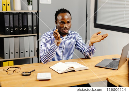 Professional man working on laptop at desk 116806224