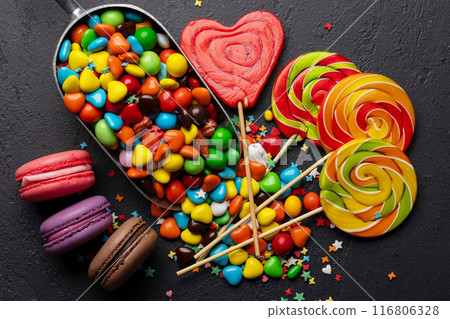 Various colorful candies, lollipops, and macaroons Various colorful candies, lollipops, and macaroons 116806328