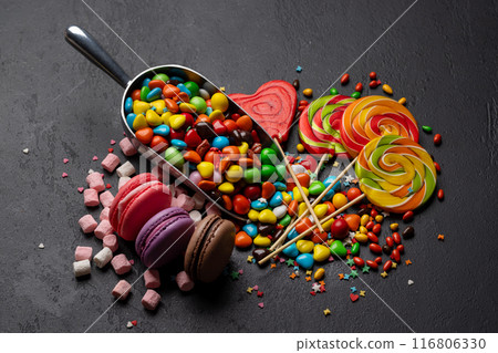 Various colorful candies, lollipops, and macaroons Various colorful candies, lollipops, and macaroons 116806330