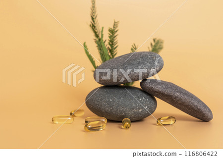 Yellow Soft Gel Capsule Omega 3, 6, 9 on Yellow Peach Background. Fish Oil, Vitamin, Food Supplement Near Stone And Green Leaves. Natural Product Concept. Copy Space. Horizontal Plane Selective Focus Yellow Soft Gel Capsule Omega 3, 6, 9 on Yellow Peach Background. Fish Oil, Vitamin, Food Supplement Near Stone And Green Leaves. Natural Product Concept. Copy Space. Horizontal Plane Selective Focus 116806422