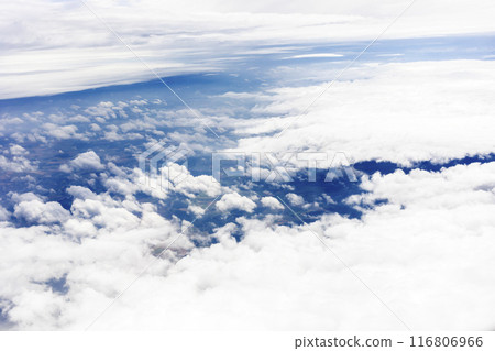 Blurred Sky View With Clouds From Plane. High Nature View Large White Cumulus Cloud At Day Time. Cloudy Blue Sky. Selective Focus. Horizontal Plane. Celestial Sphere. Weather Forecast. Blurred Sky View With Clouds From Plane. High Nature View Large White Cumulus Cloud At Day Time. Cloudy Blue Sky. Selective Focus. Horizontal Plane. Celestial Sphere. Weather Forecast. 116806966