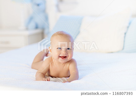 Little baby on white bed 116807393