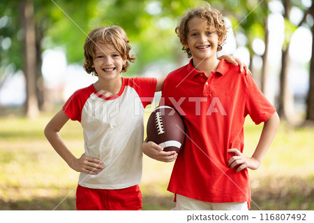 Family playing American football. Kids play rugby 116807492