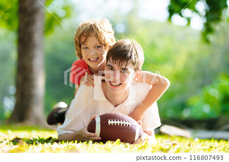 Family playing American football. Kids play rugby 116807493