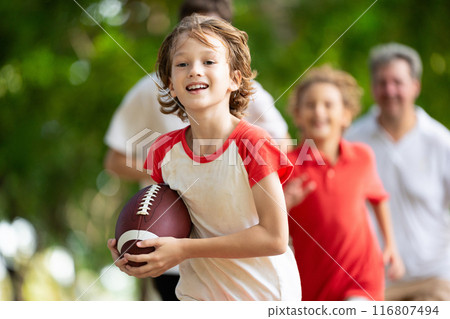 Family playing American football. Kids play rugby Family playing American football. Kids play rugby 116807494
