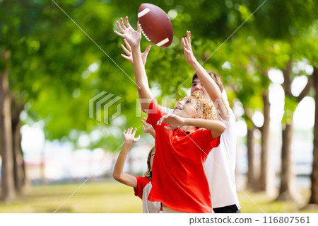 Family playing American football. Kids play rugby 116807561