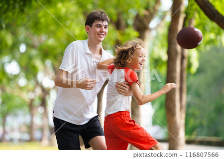 Family playing American football. Kids play rugby 116807566