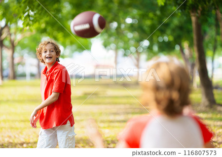 Family playing American football. Kids play rugby 116807573