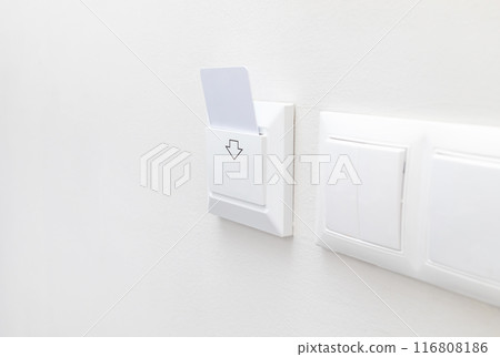 Hotel White Key Card Reader With Card For Powering Electricity. Hotel Key Card On Main Switch To Enable The Electric Circuit In Hotel Rooms. Horizontal Plane. Copy Space. Energy Saving 116808186
