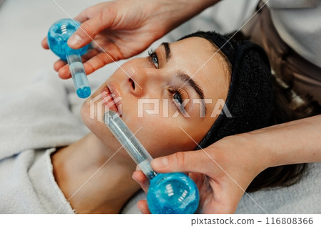 The master gives the client a relaxing facial massage using cold cryo spheres. 116808366
