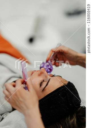 The master gives the client a relaxing facial massage using cold cryo spheres. The master gives the client a relaxing facial massage using cold cryo spheres. 116808419