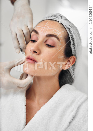 A woman gets injections in the face. A woman gets injections in the face. 116808454