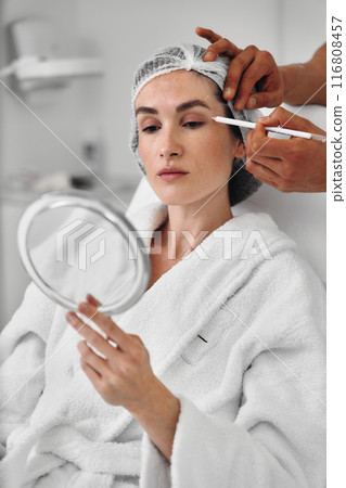 A woman gets injections in the face. A woman gets injections in the face. 116808457