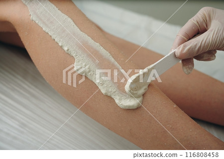 A woman receives a foot massage with peeling. A woman receives a foot massage with peeling. 116808458
