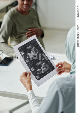 Doctor discussing sonogram with patient Doctor discussing sonogram with patient 116808630