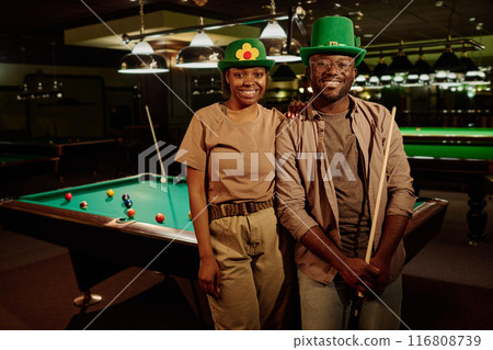 Happy young couple in green Irish hats 116808739