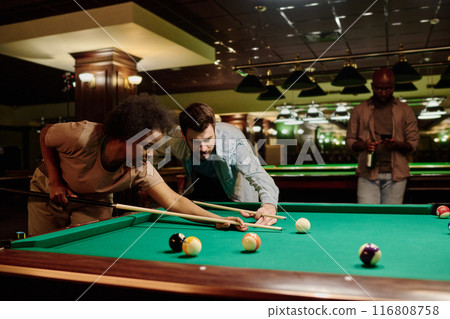 Young billiards players with cues 116808758