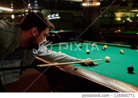 Bending over table with billiards balls Bending over table with billiards balls 116808771