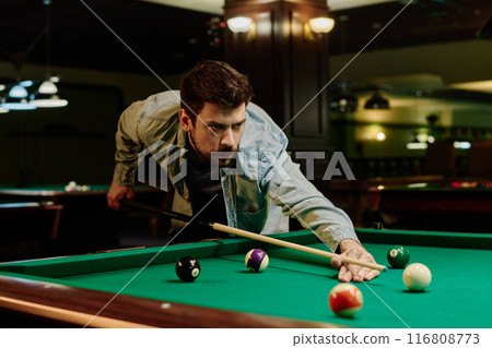 Man bending over pool table during game Man bending over pool table during game 116808773