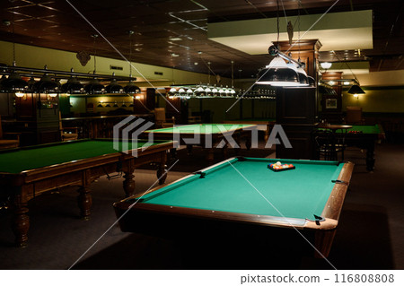 Stylish lamps lighting billiards tables 116808808